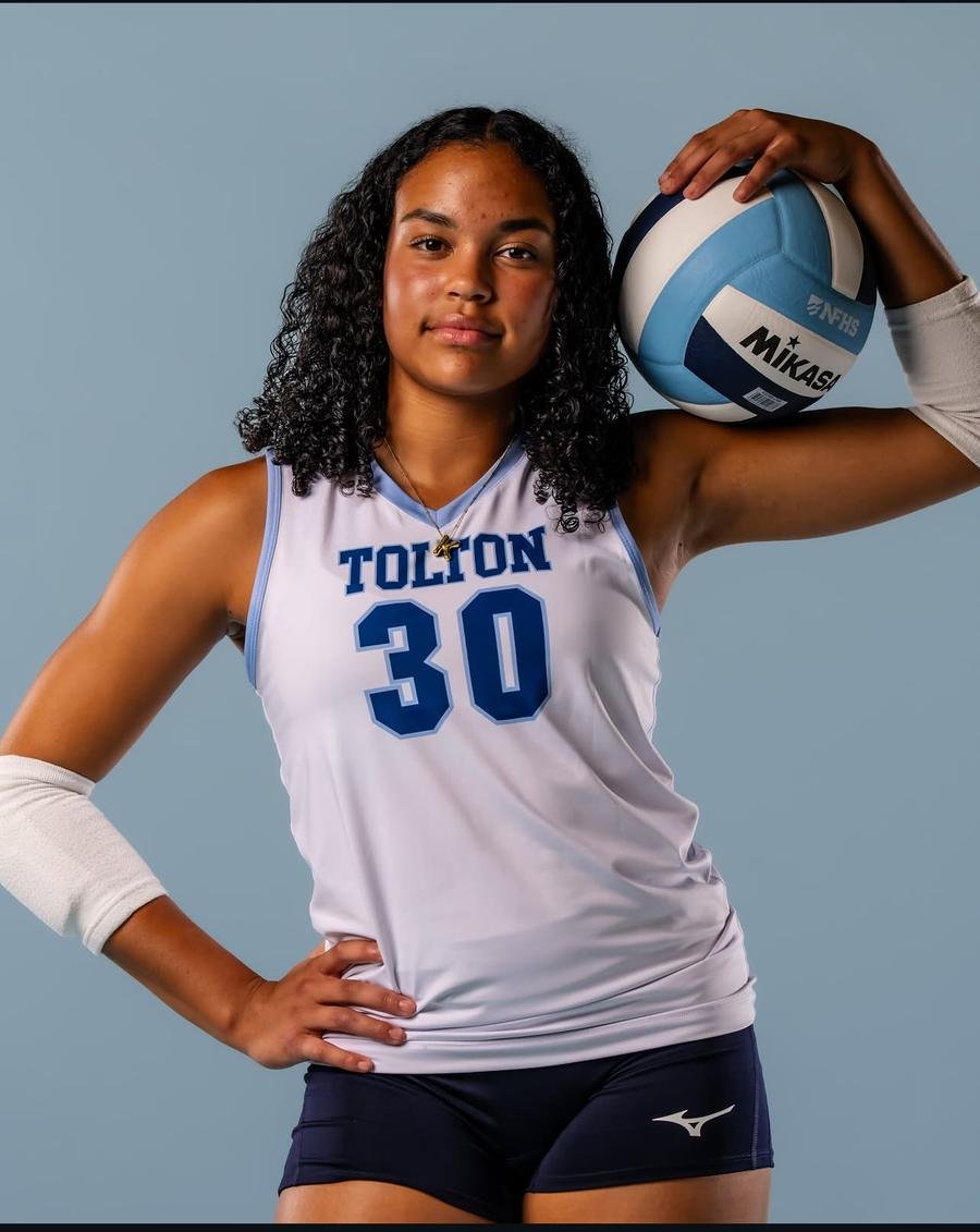 Volleyball player with a ball on her shoulder