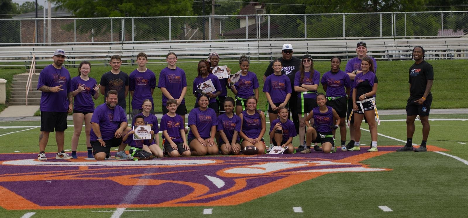 Girls flag football campers in purple BSP shirts